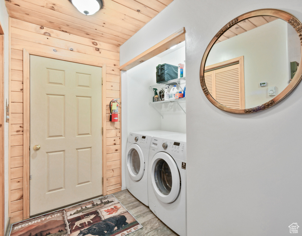 Laundry area featuring separate washer and dryer and wooden ceiling