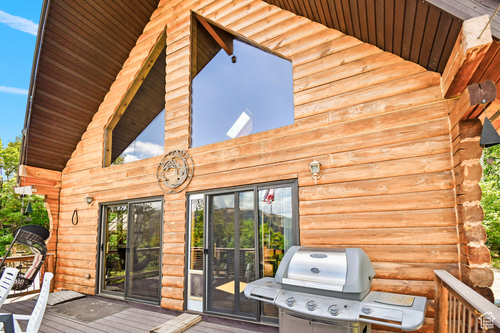 Wooden terrace featuring area for grilling