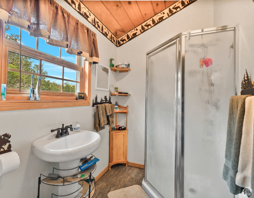 Full bathroom with wood finished floors, a stall shower, and wooden ceiling