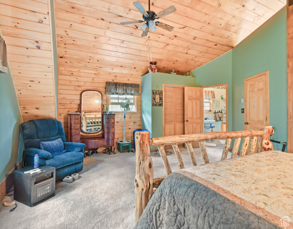 Carpeted bedroom with lofted ceiling, wood ceiling, and a closet