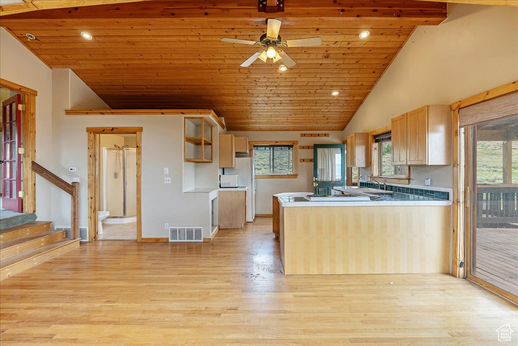 Kitchen featuring wood ceiling, light wood-type flooring, lofted ceiling, plenty of natural light, and ceiling fan