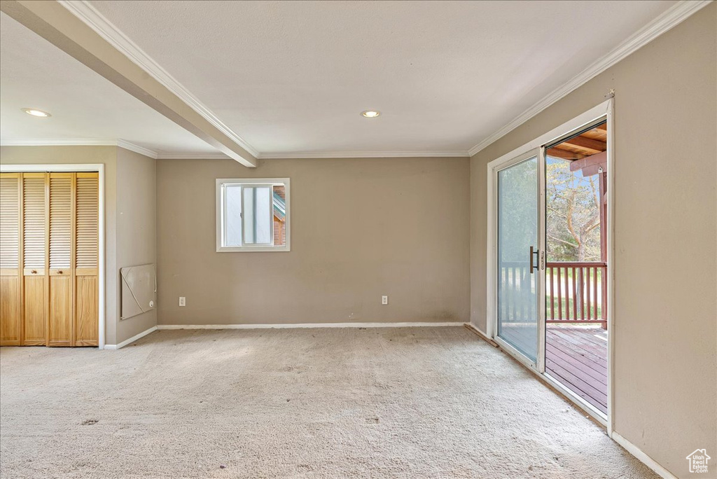 Carpeted empty room with ornamental molding and recessed lighting
