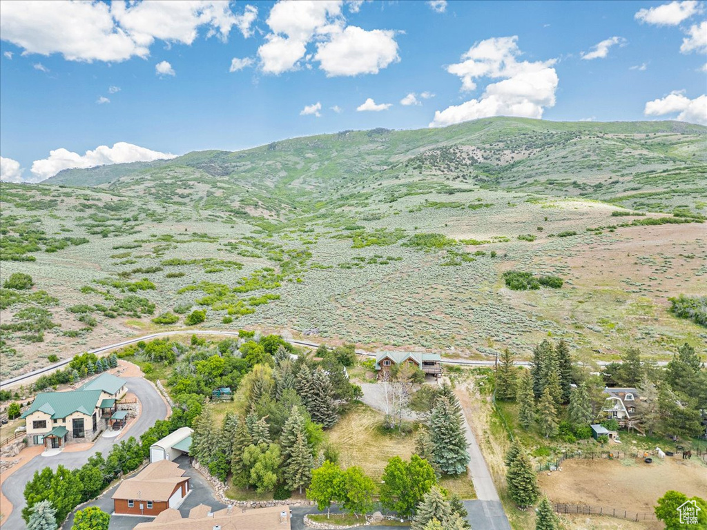 Aerial view of property and surrounding area featuring mountains