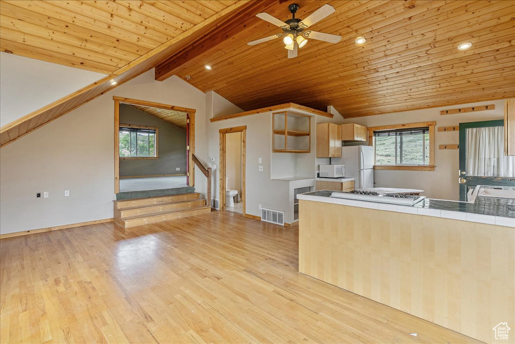 Kitchen with white appliances, wooden ceiling, light wood finished floors, healthy amount of natural light, and ceiling fan