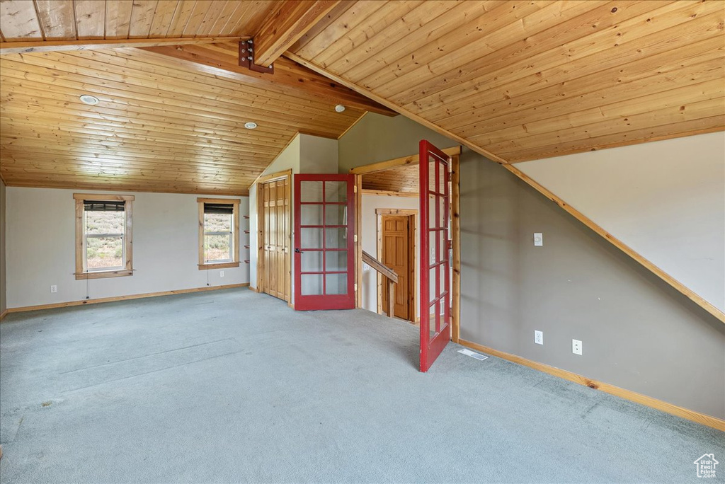 Bonus room with lofted ceiling, carpet, and wooden ceiling