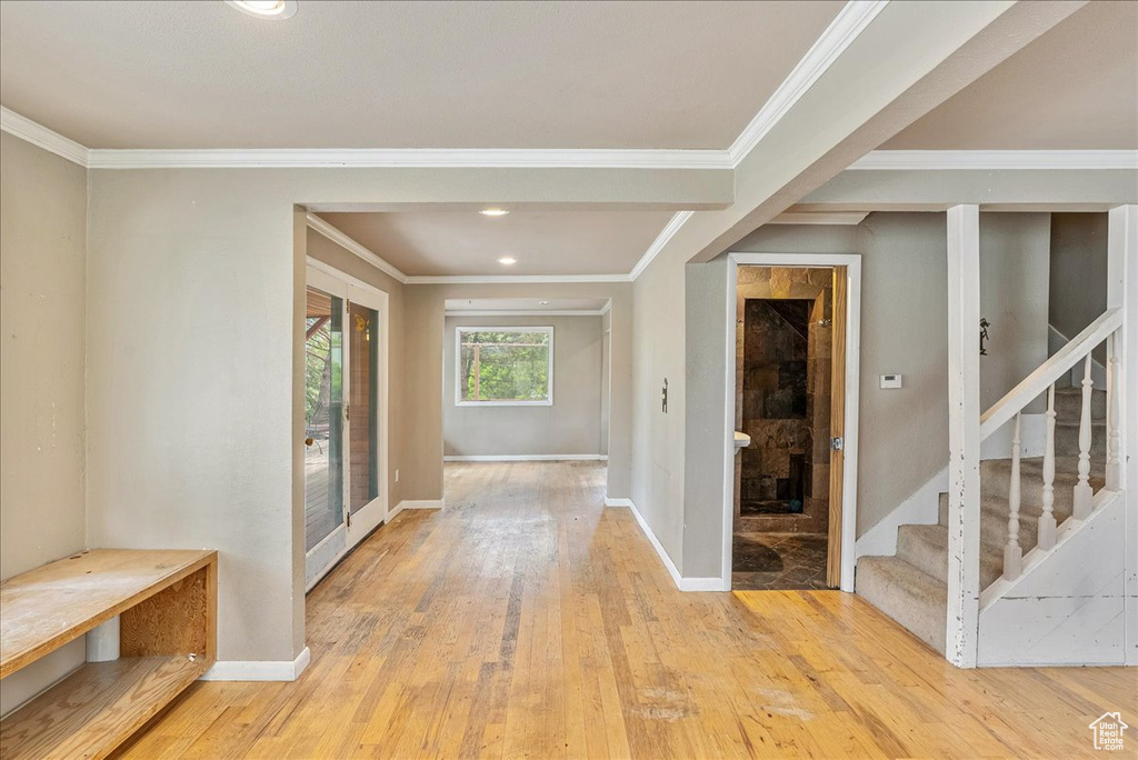 Foyer featuring stairway, wood-type flooring, ornamental molding, and recessed lighting