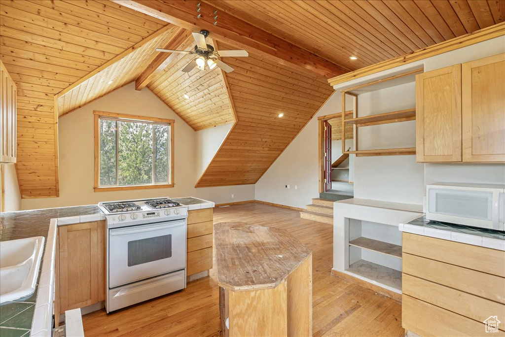 Kitchen with white appliances, light brown cabinets, open shelves, wood ceiling, and tile countertops