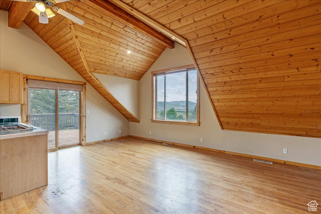 Bonus room featuring wood ceiling, plenty of natural light, light wood-type flooring, and ceiling fan