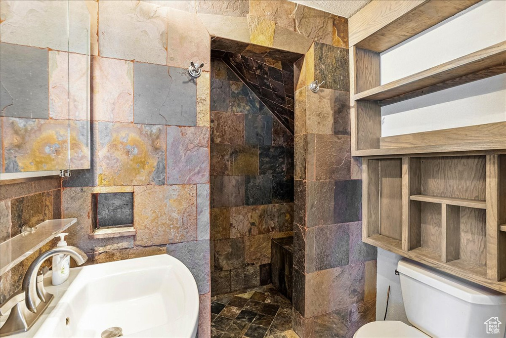 Full bathroom with walk in shower and tile walls