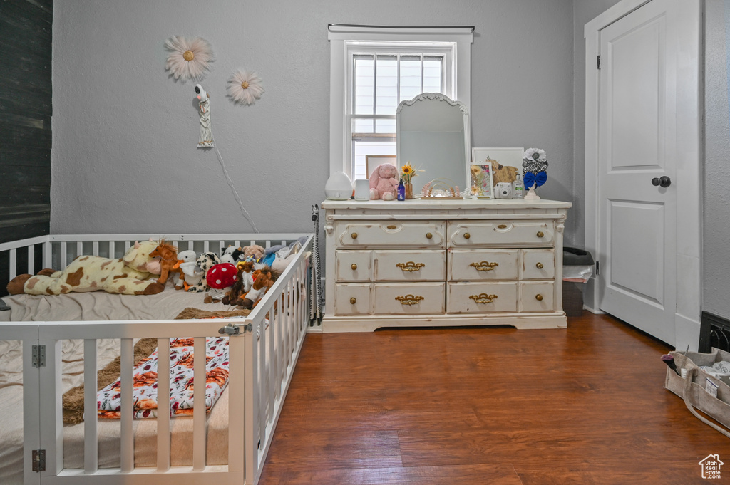 Bedroom featuring dark wood-type flooring