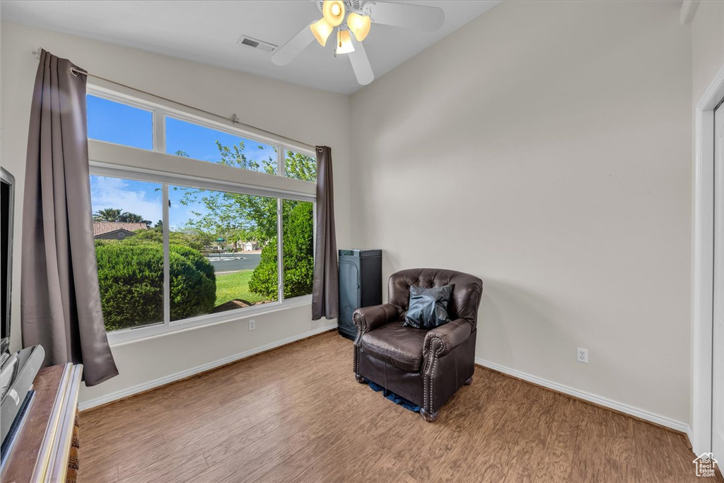 Unfurnished room featuring wood finished floors and a ceiling fan