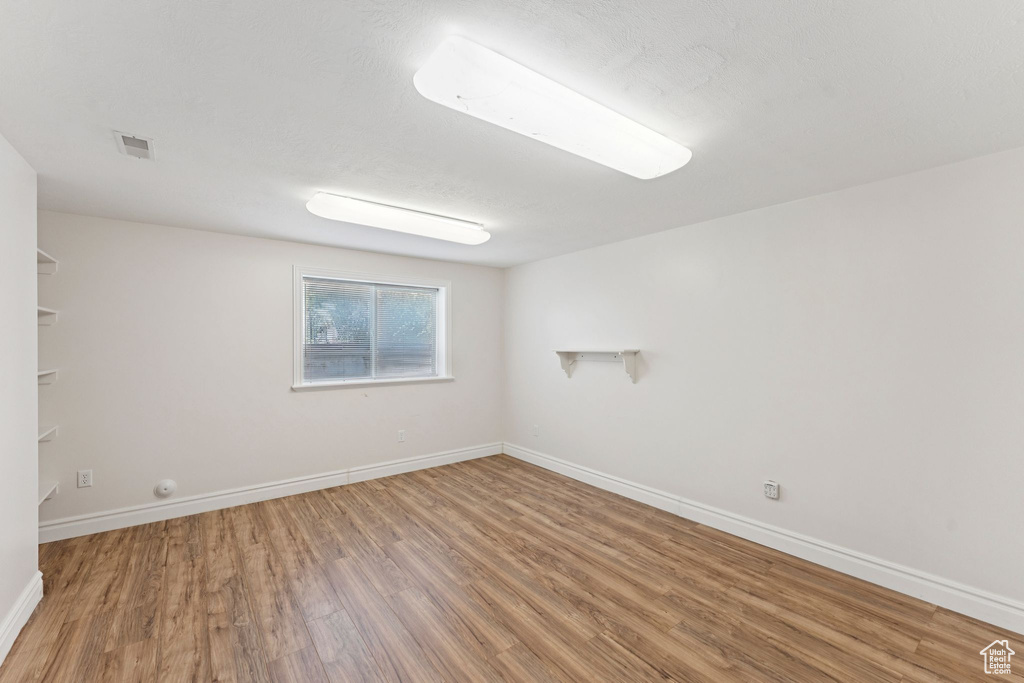 Spare room featuring wood finished floors