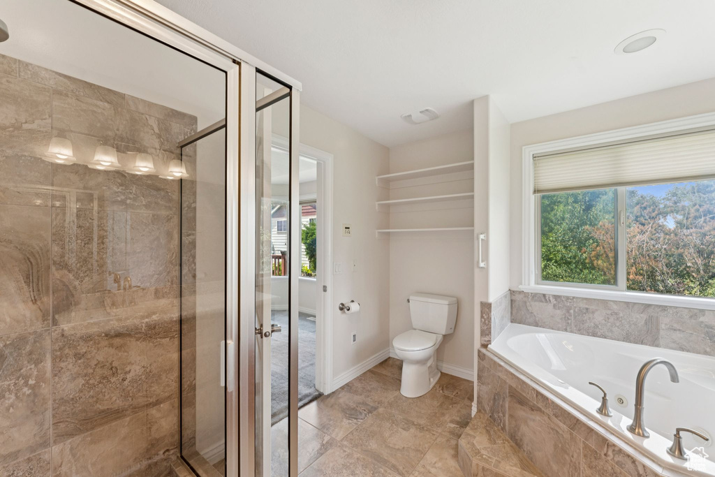 Full bath with a garden tub, a shower stall, and plenty of natural light