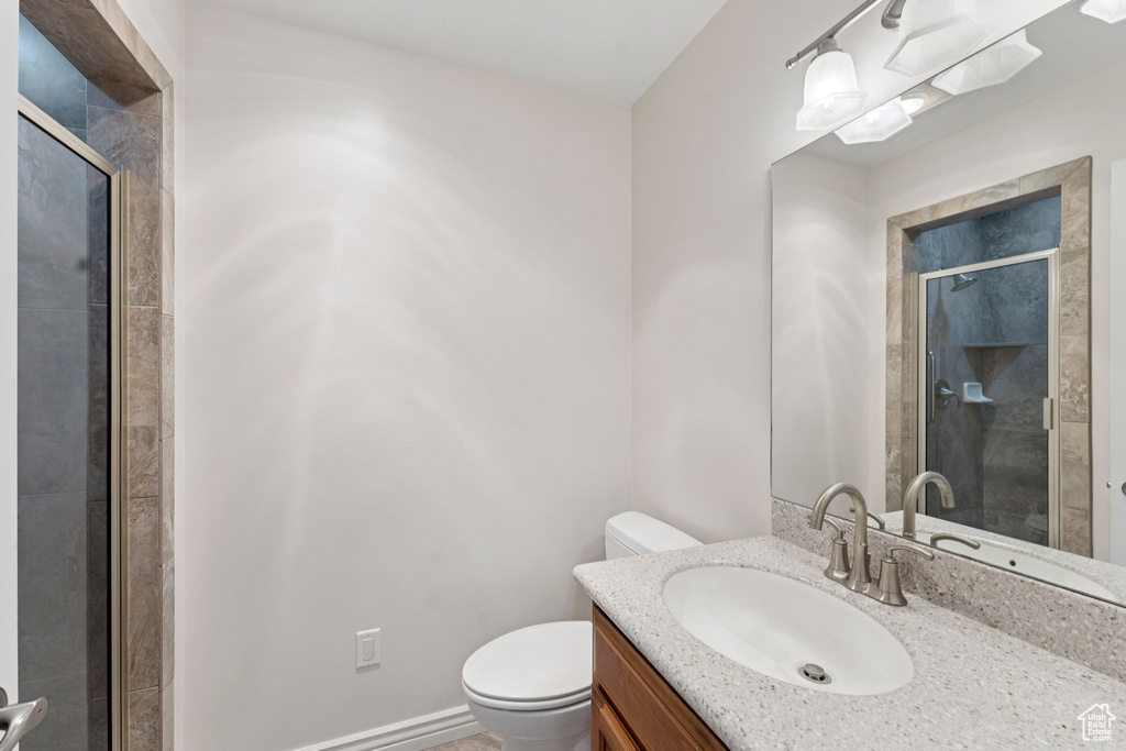 Bathroom with a shower stall and vanity