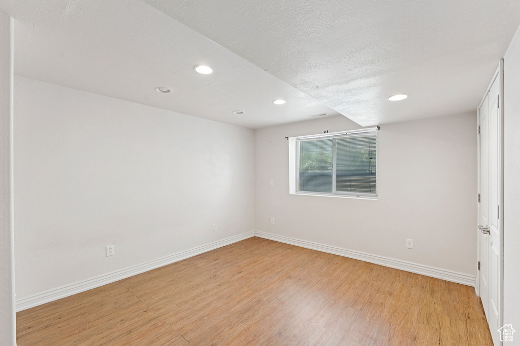 Unfurnished room featuring light wood finished floors and recessed lighting