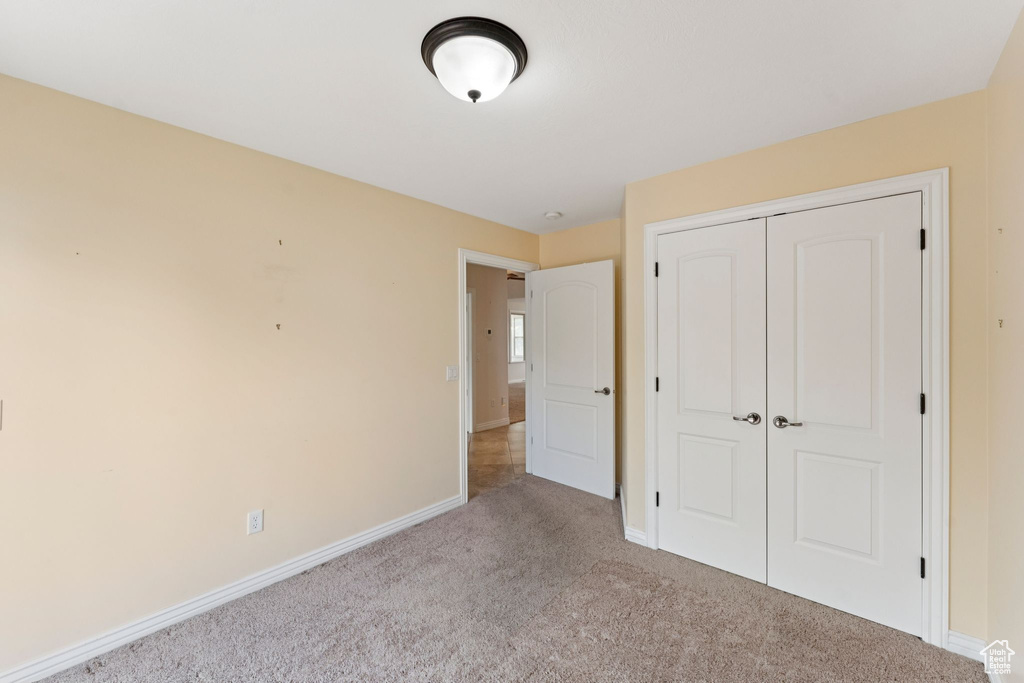 Unfurnished bedroom featuring carpet floors and a closet