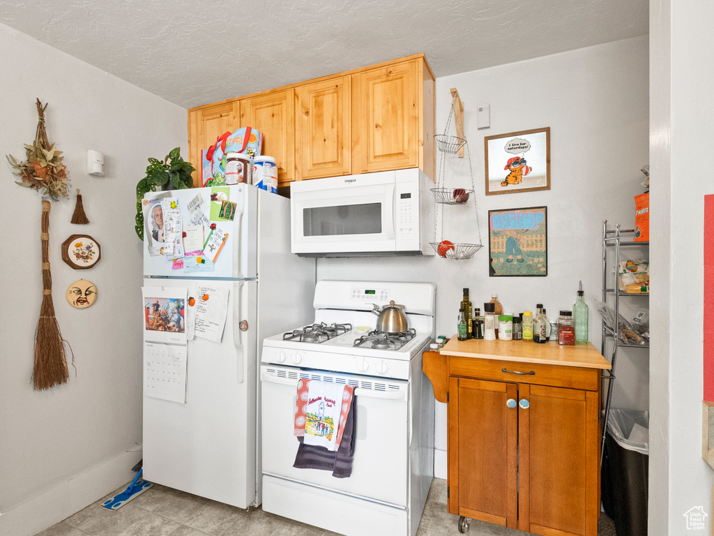 Kitchen with white appliances and light countertops