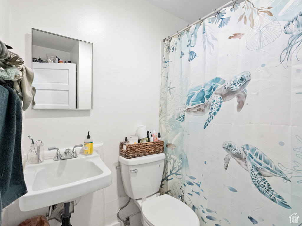 Full bath with toilet and curtained shower