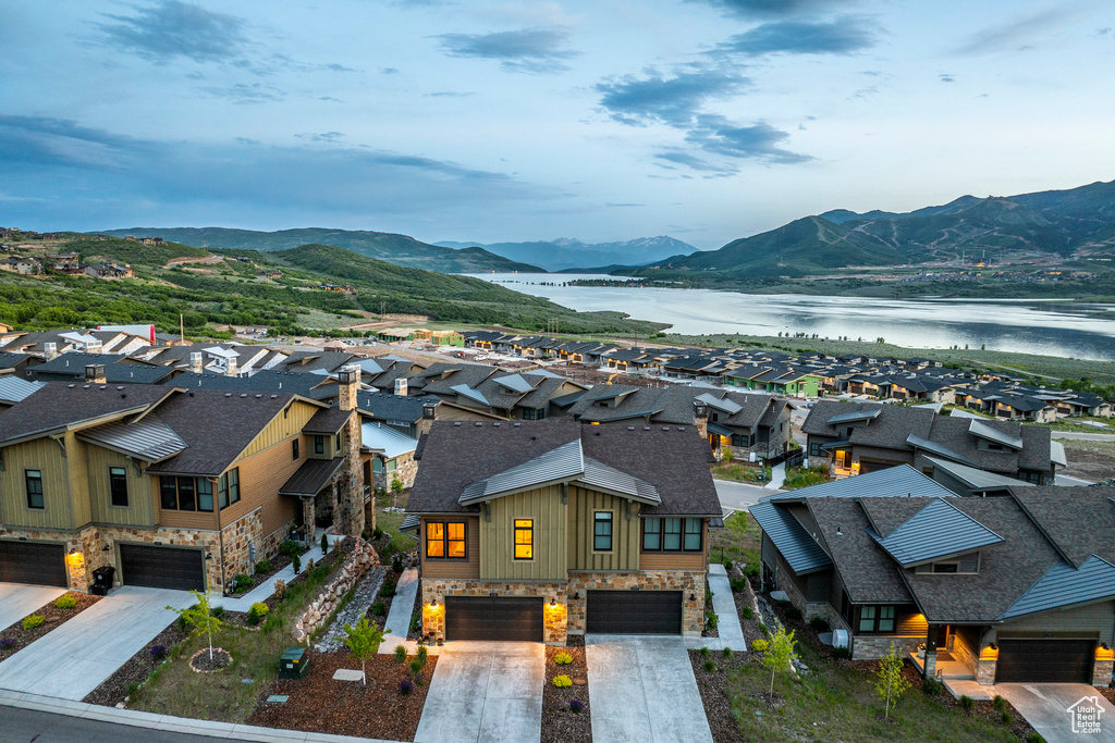 View of mountain backdrop with a nearby body of water and nearby suburban area