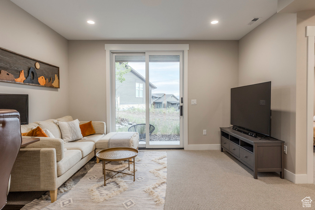 Living room with recessed lighting and carpet