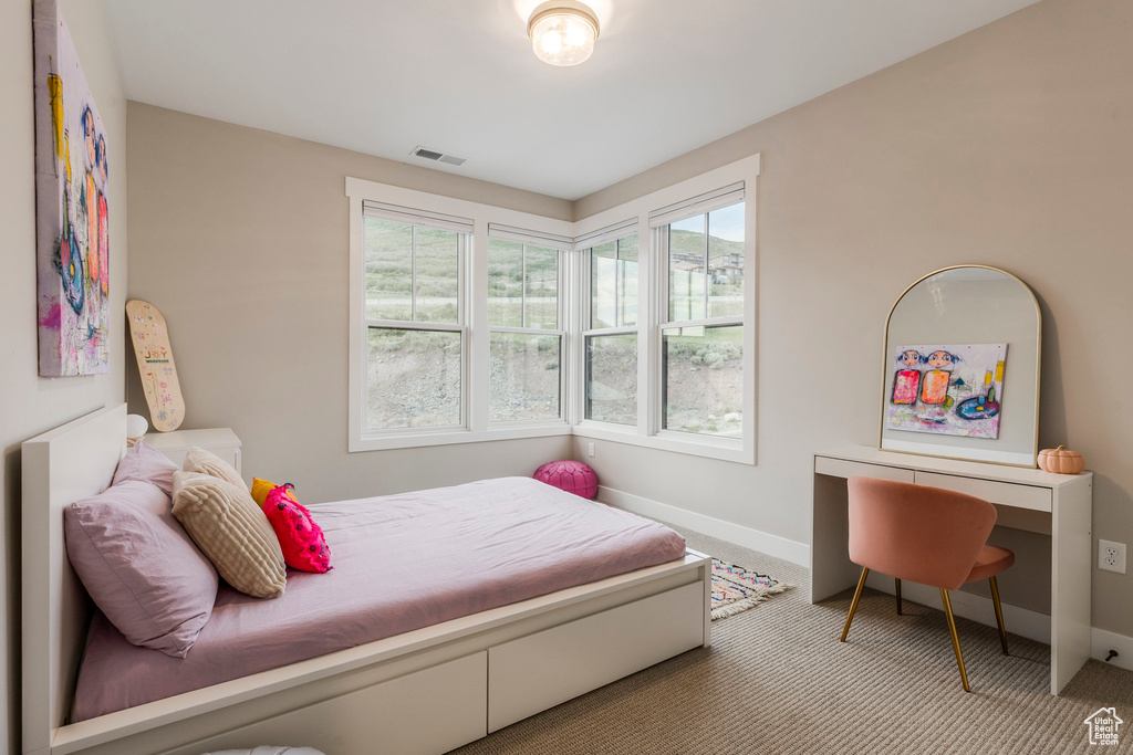 Bedroom with carpet floors and baseboards