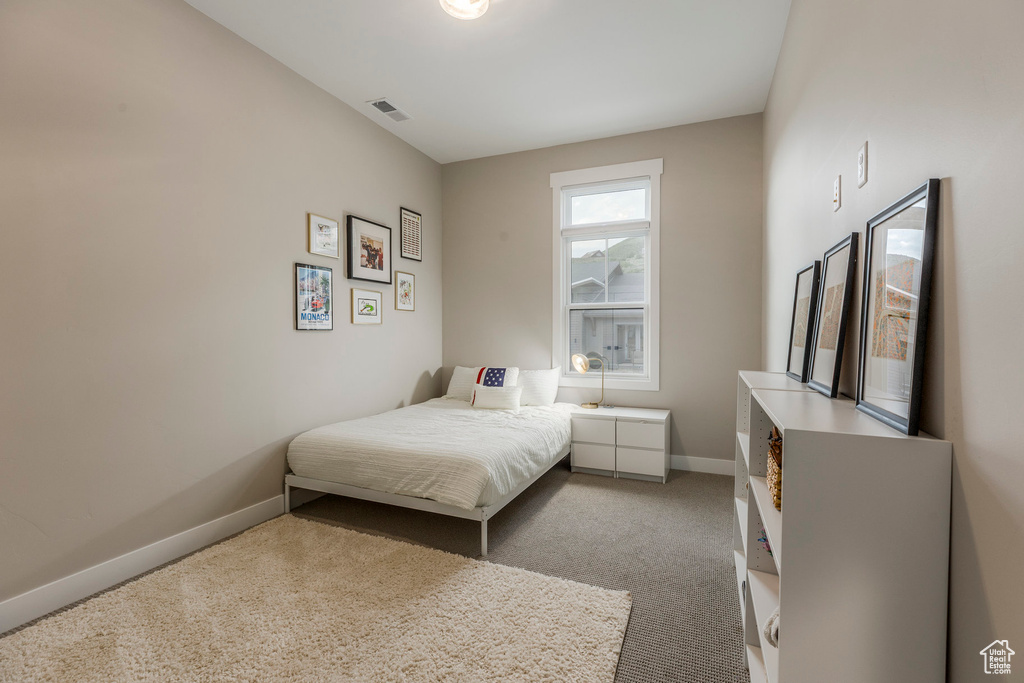 Carpeted bedroom with baseboards