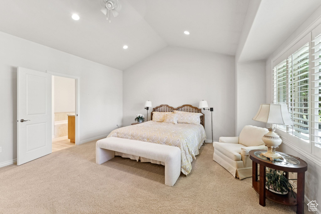 Bedroom featuring multiple windows, light carpet, recessed lighting, lofted ceiling, and ensuite bathroom