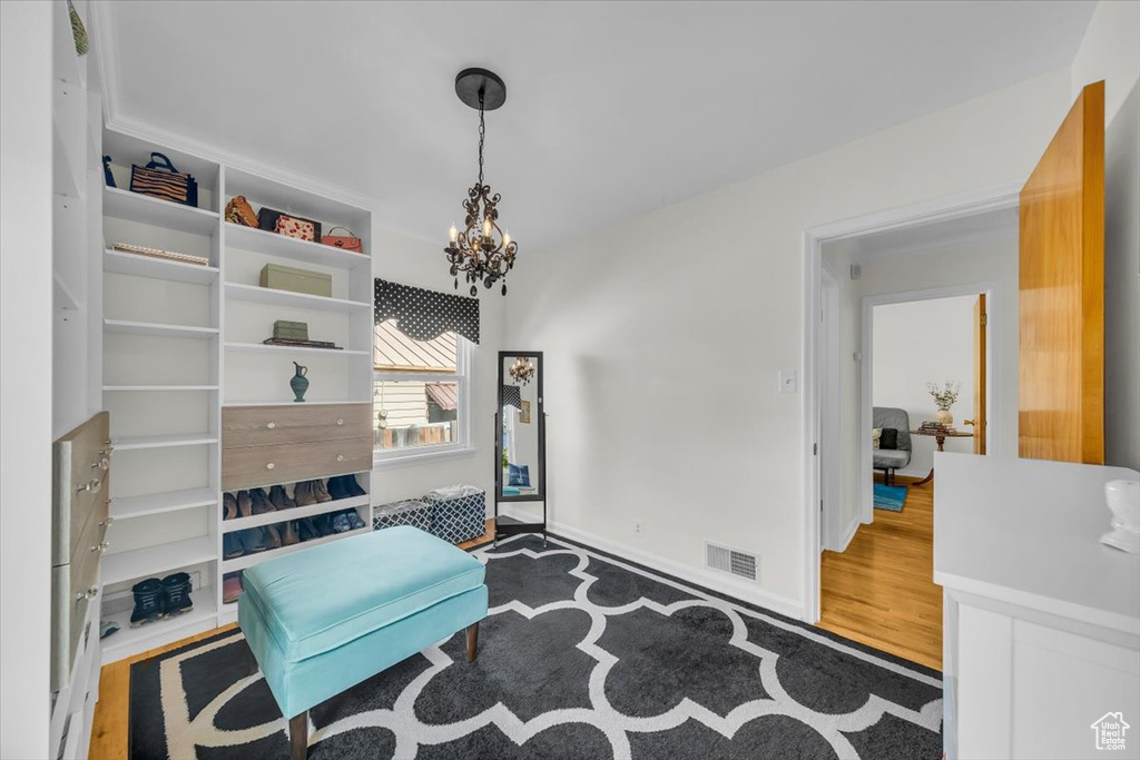 Living area featuring a chandelier and wood finished floors