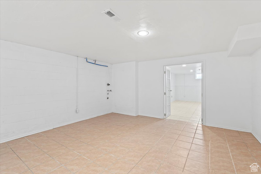 Empty room with light tile patterned floors