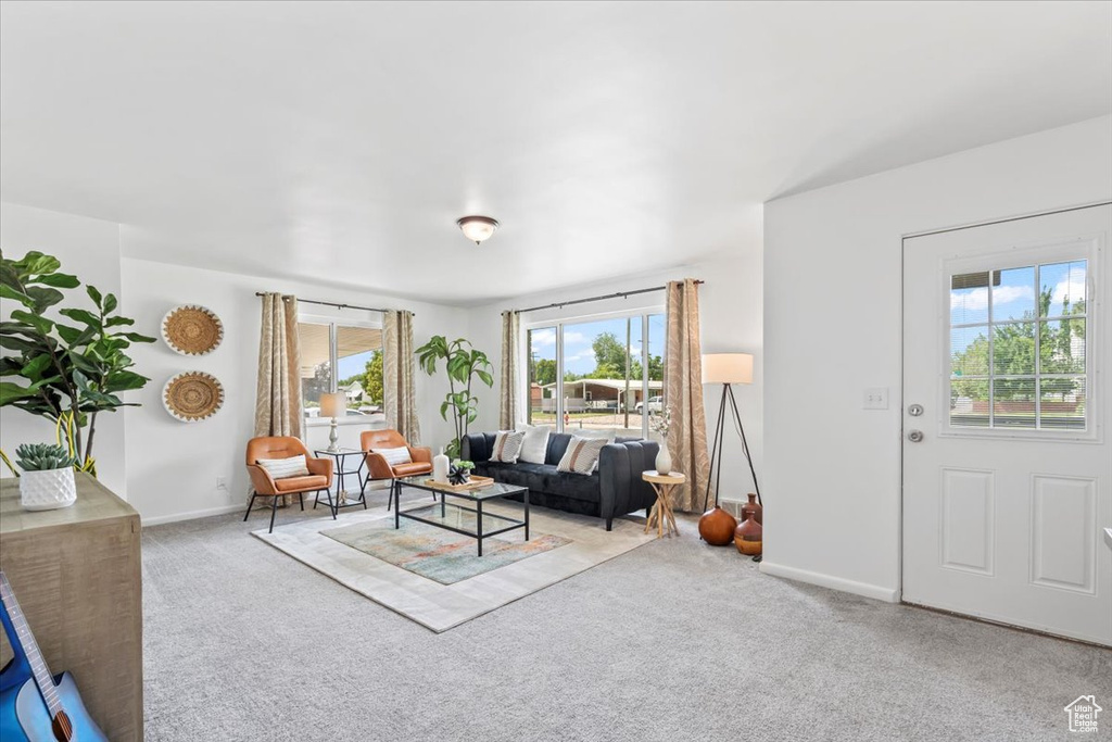 Living area featuring carpet flooring and baseboards
