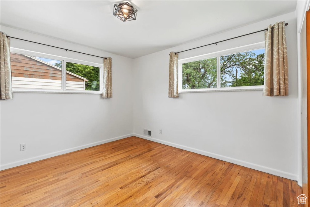 Spare room with plenty of natural light and light wood-style floors