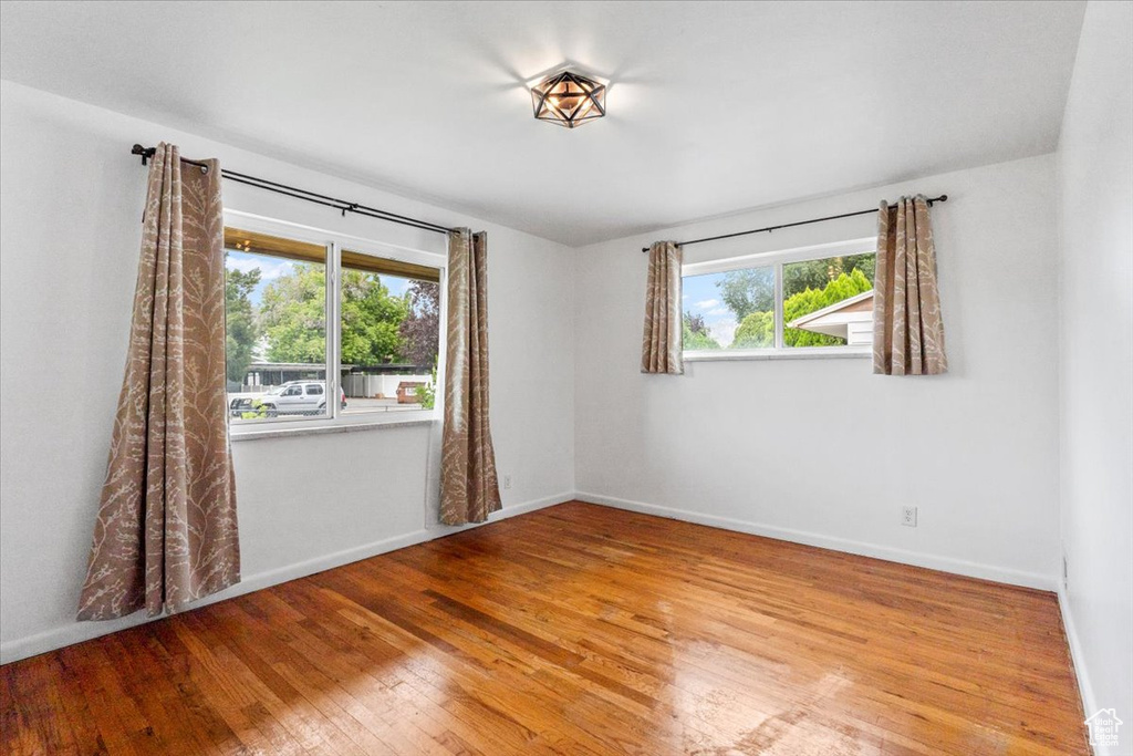 Spare room featuring hardwood / wood-style flooring and baseboards