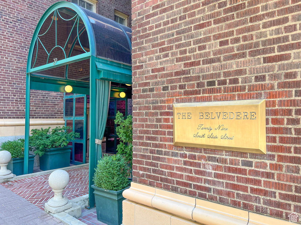 Entrance to property featuring brick siding