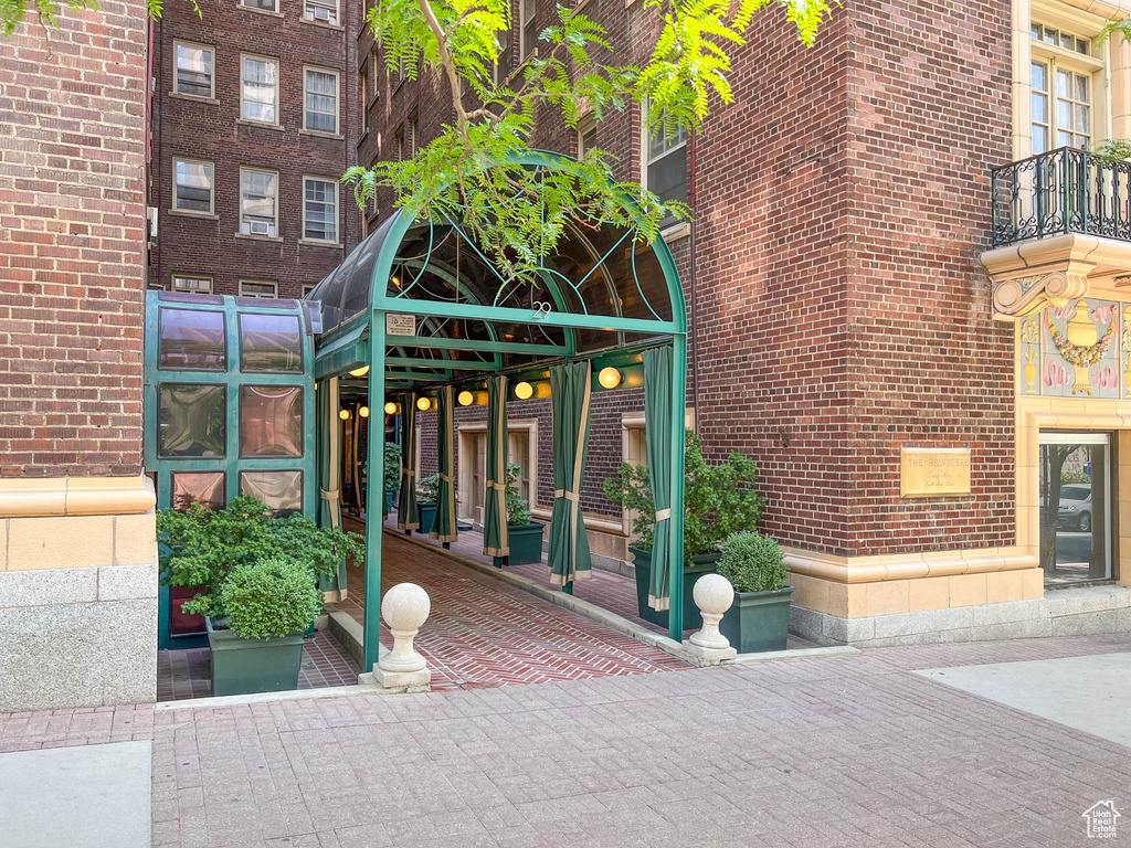 Entrance to property featuring brick siding