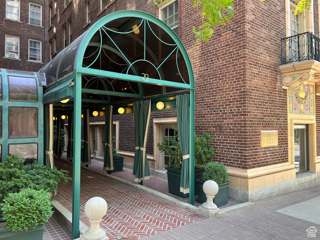 View of exterior entry featuring brick siding