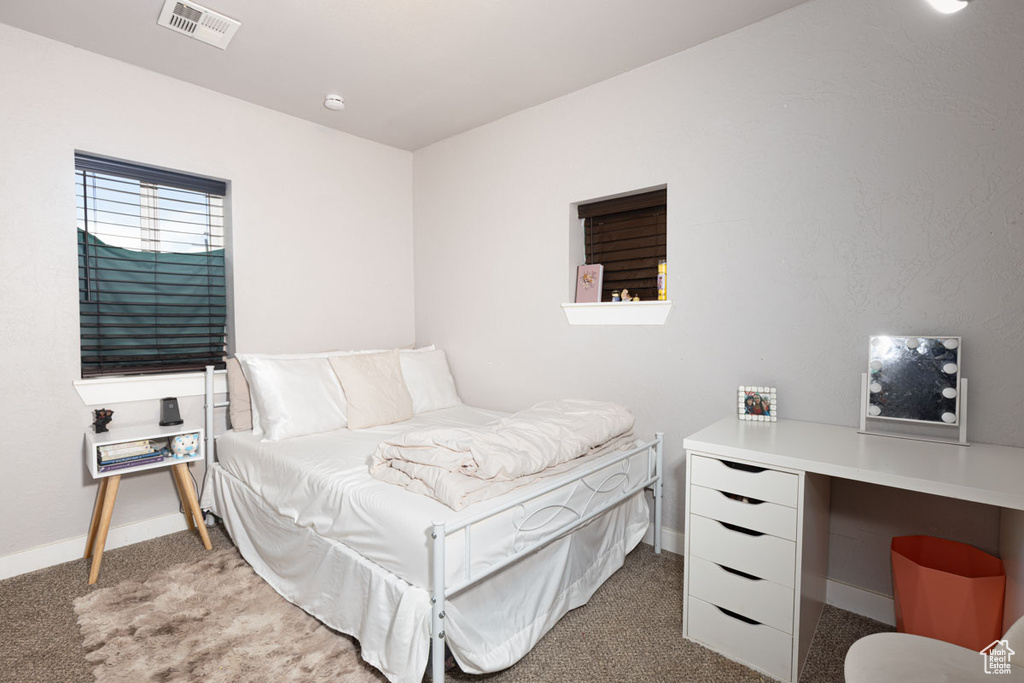 Bedroom with baseboards and carpet flooring