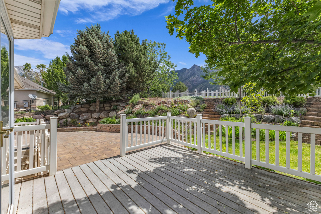 Deck with a mountain view and a patio