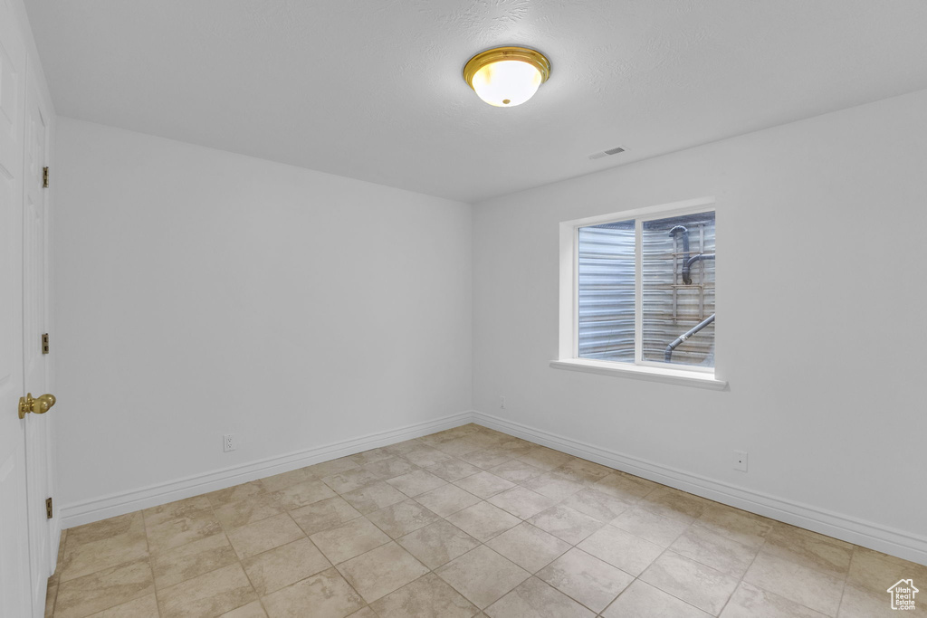 Empty room featuring baseboards