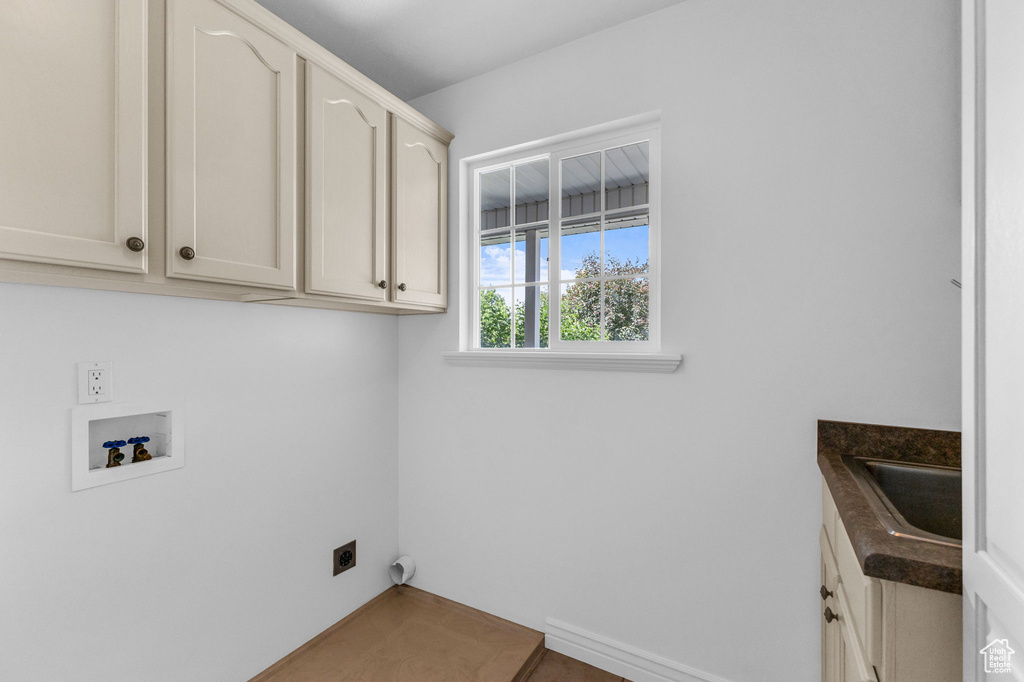 Laundry room with cabinet space, washer hookup, and hookup for an electric dryer