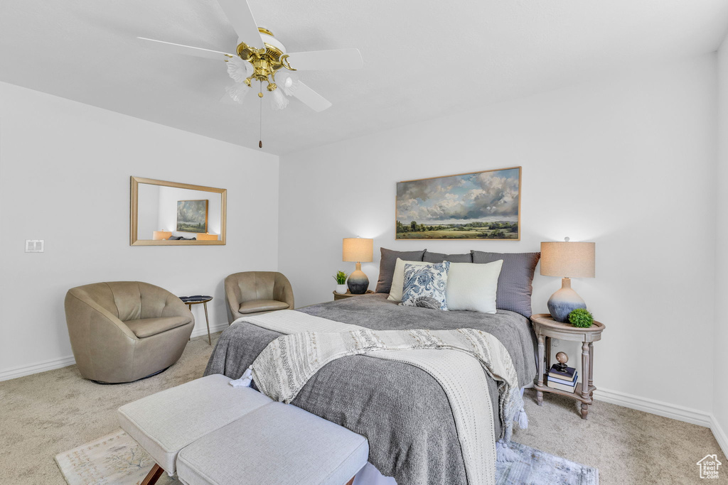 Carpeted bedroom with baseboards and a ceiling fan