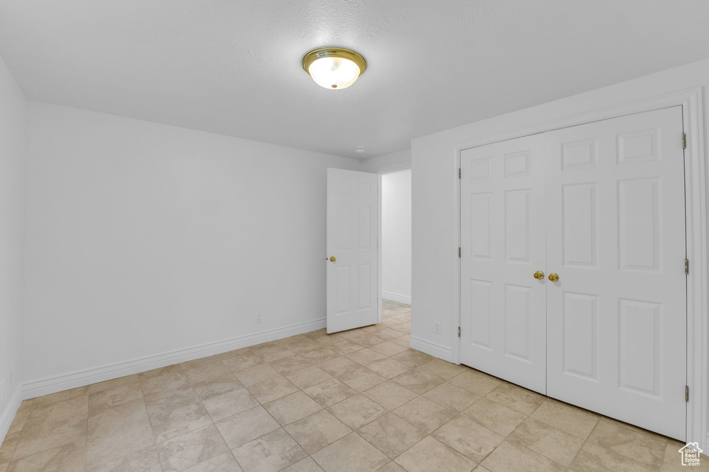 Unfurnished bedroom with a closet and baseboards