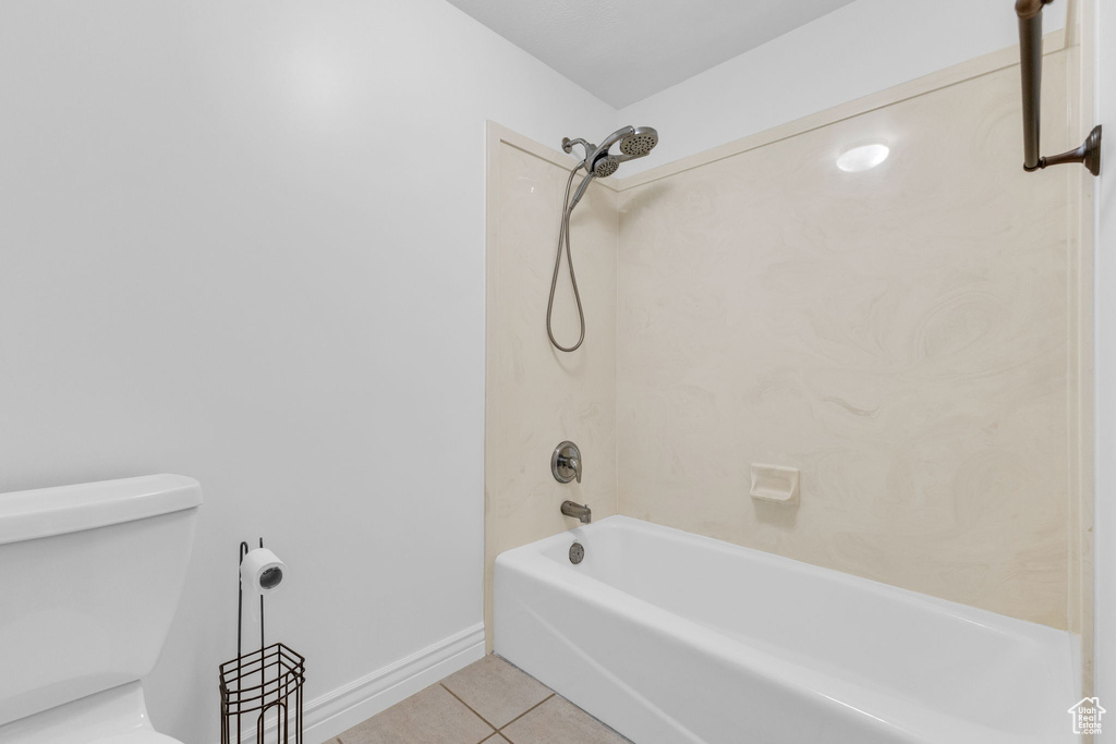 Full bath with tile patterned flooring and washtub / shower combination
