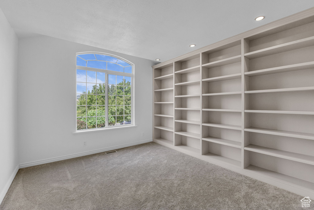 Carpeted spare room featuring baseboards and recessed lighting