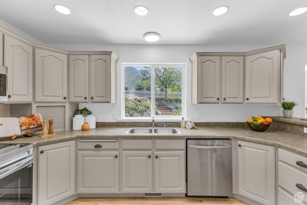 Kitchen with appliances with stainless steel finishes and recessed lighting