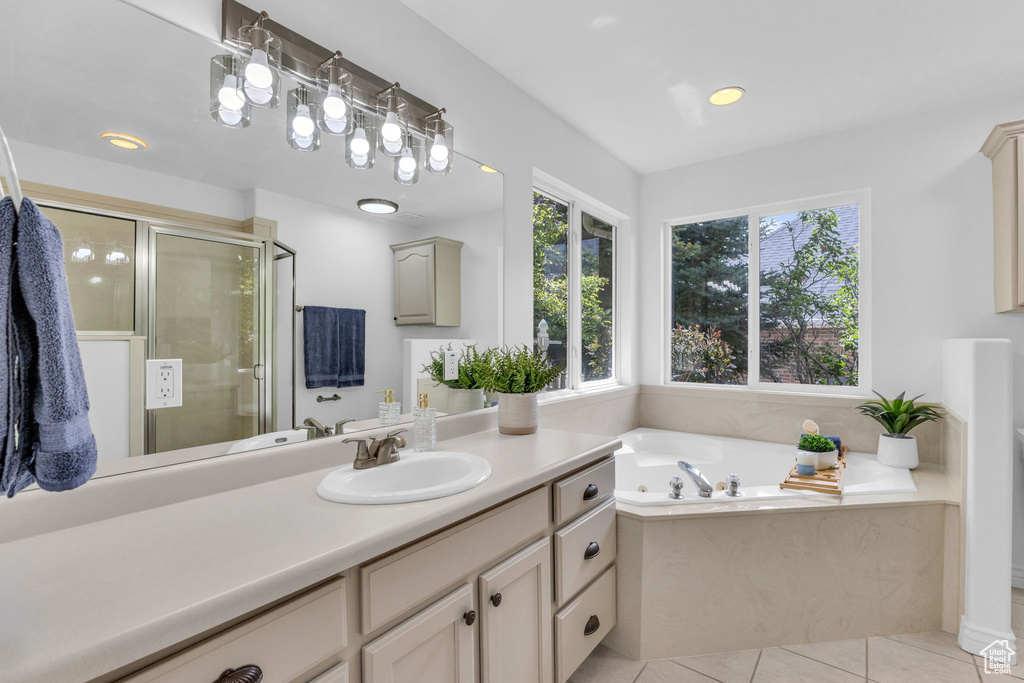 Full bathroom featuring vanity, a garden tub, a shower stall, tile patterned floors, and recessed lighting