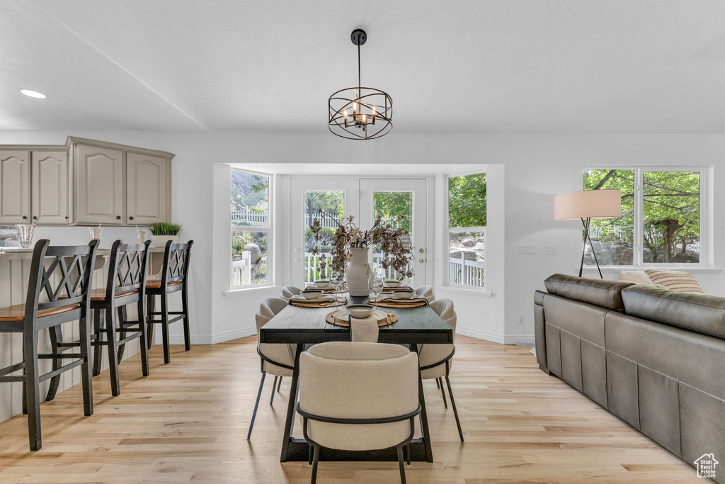 Dining space featuring plenty of natural light, light wood-style flooring, a chandelier, and recessed lighting