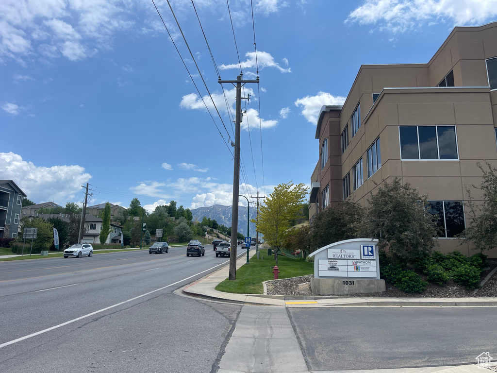 View of asphalt road with curbs and a mountain view