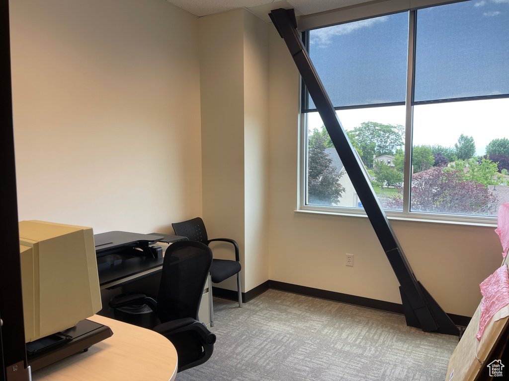 Carpeted office featuring baseboards