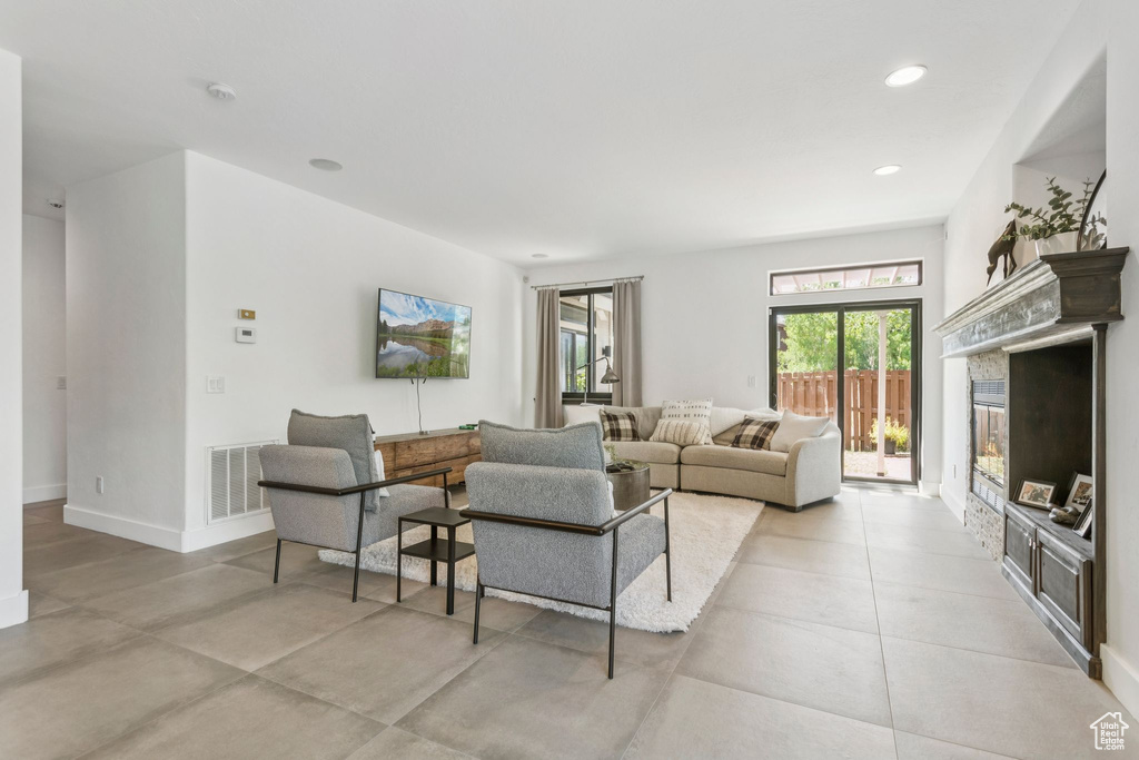 Living area featuring a glass covered fireplace and recessed lighting