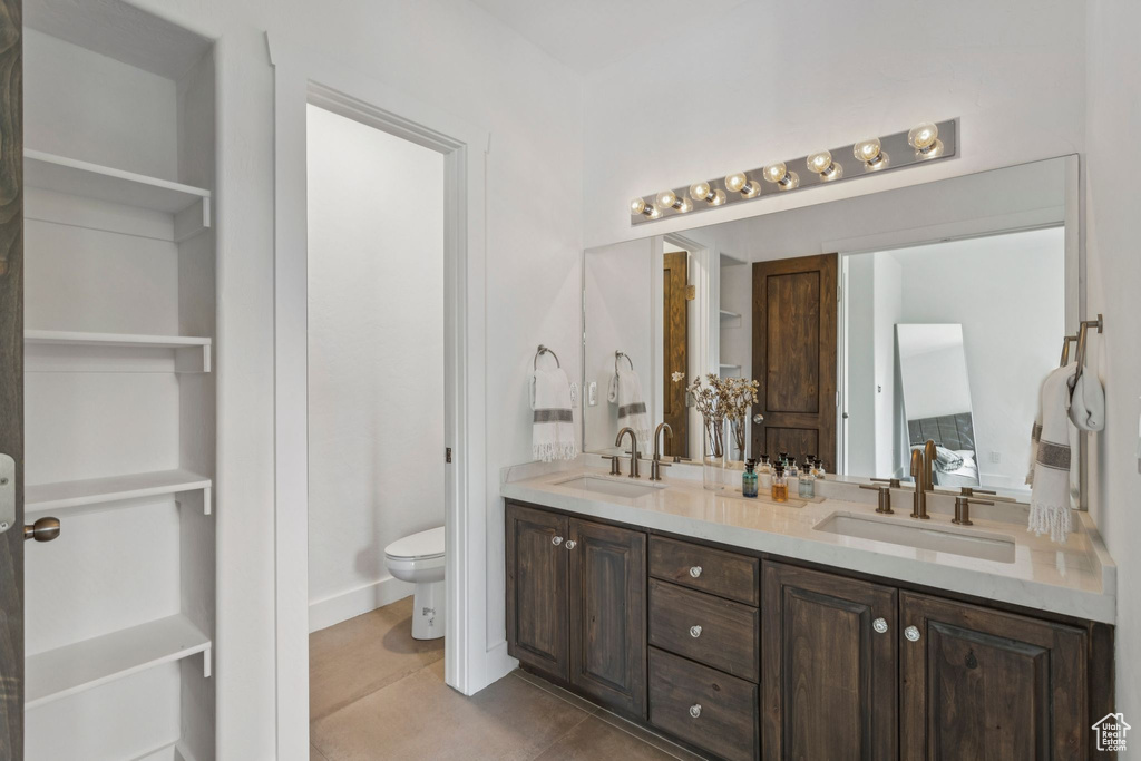 Bathroom with double vanity and tile patterned floors